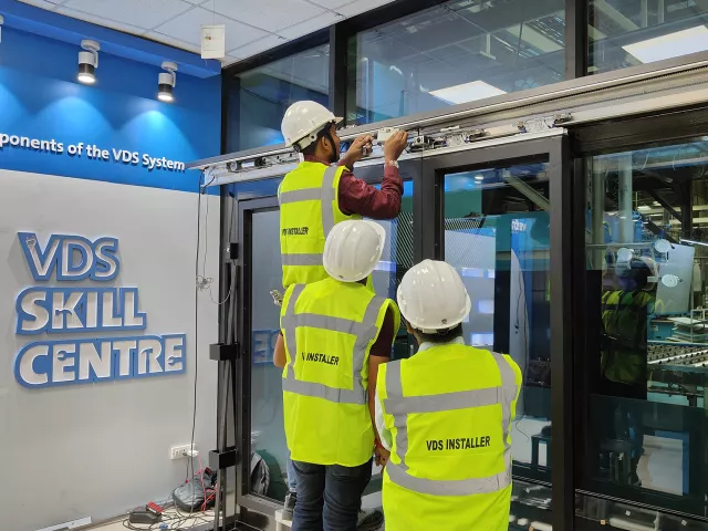 Vetrotech VDS certified installers installing a fire-rated system.