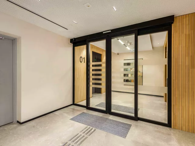 Brookfield’s fire-rated sliding glass doors with black frames and frosted stripes by Vetrotech.