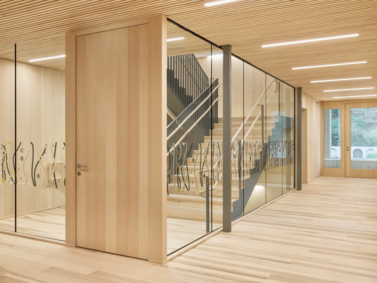 An indoor picture of a glass and timber partition