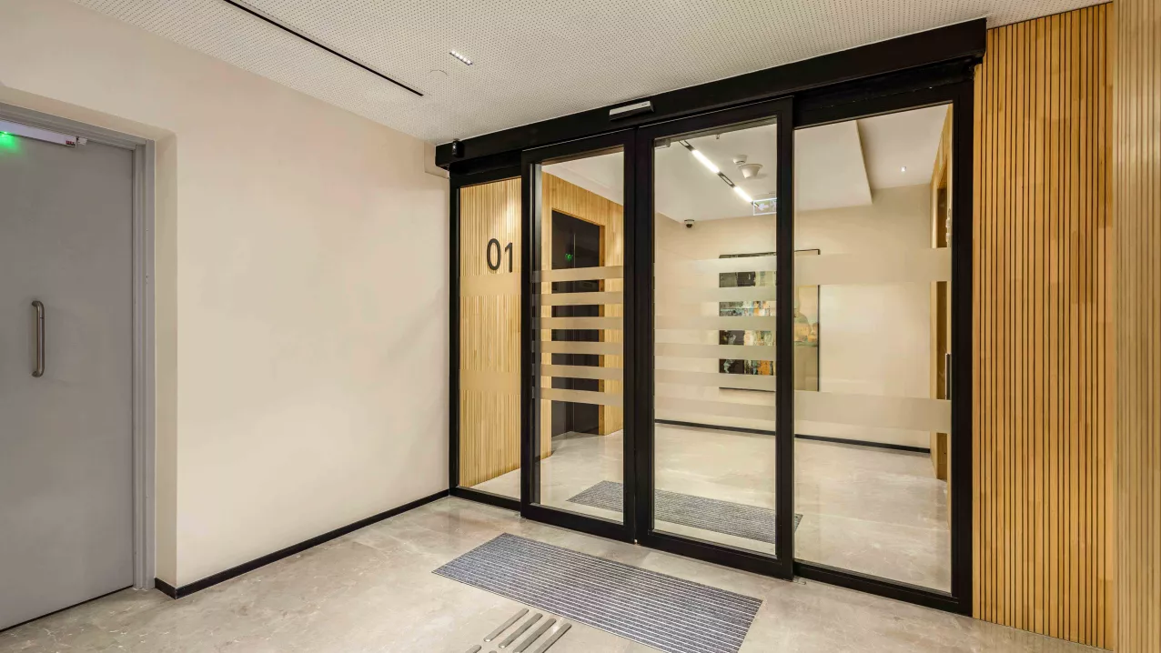 Brookfield’s fire-rated sliding glass doors with black frames and frosted stripes by Vetrotech.