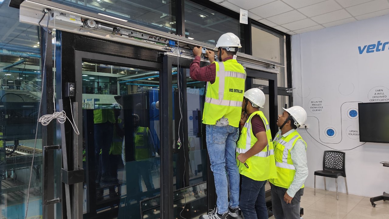 Vetrotech certified installers working on glass door installation.