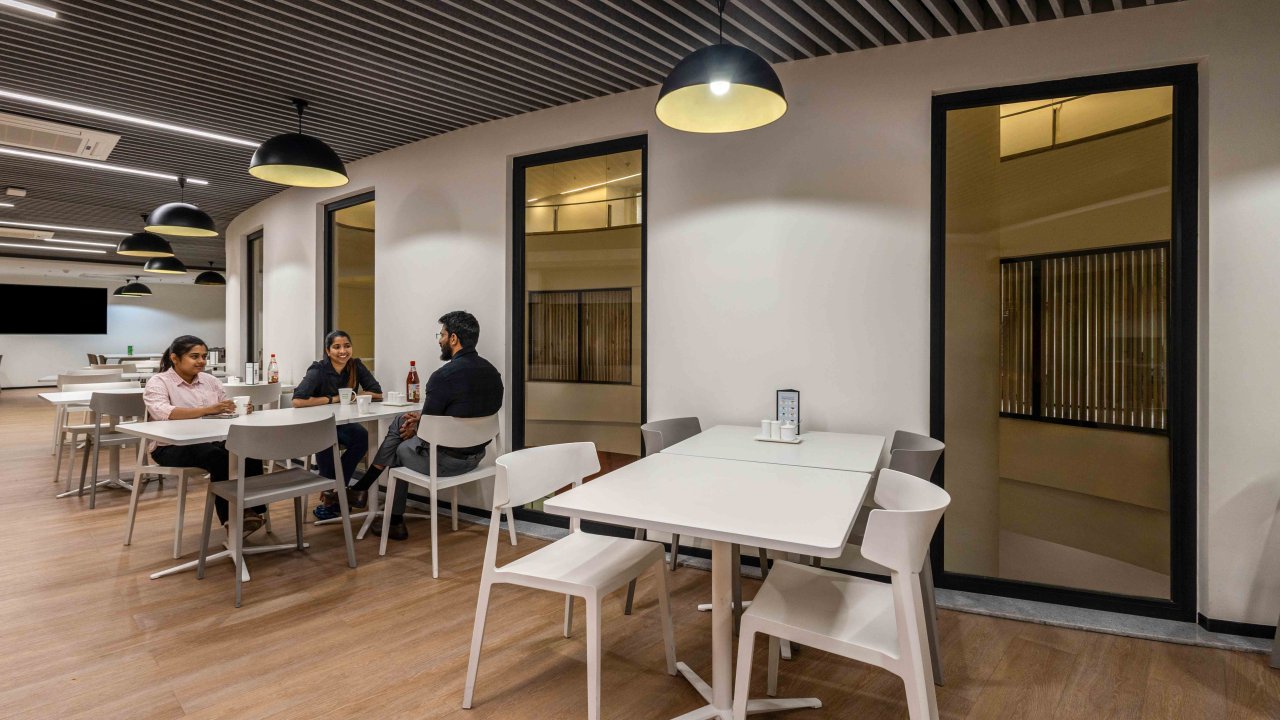 Cafeteria at Brookfield Properties with people seated at tables, featuring fire-resistant glass partitions